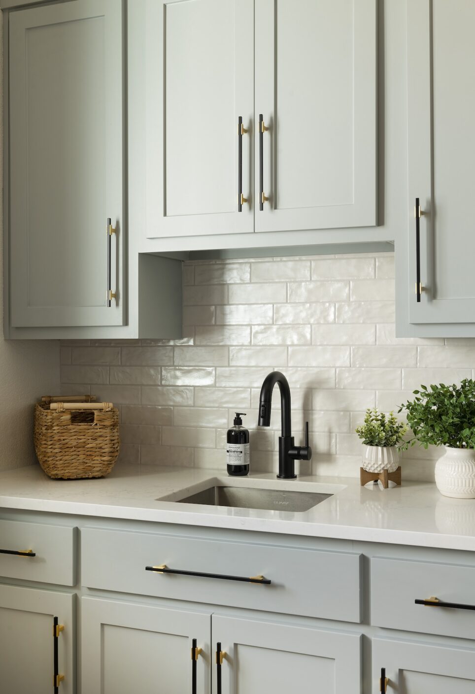 Sink With Black Faucet And White Countertop