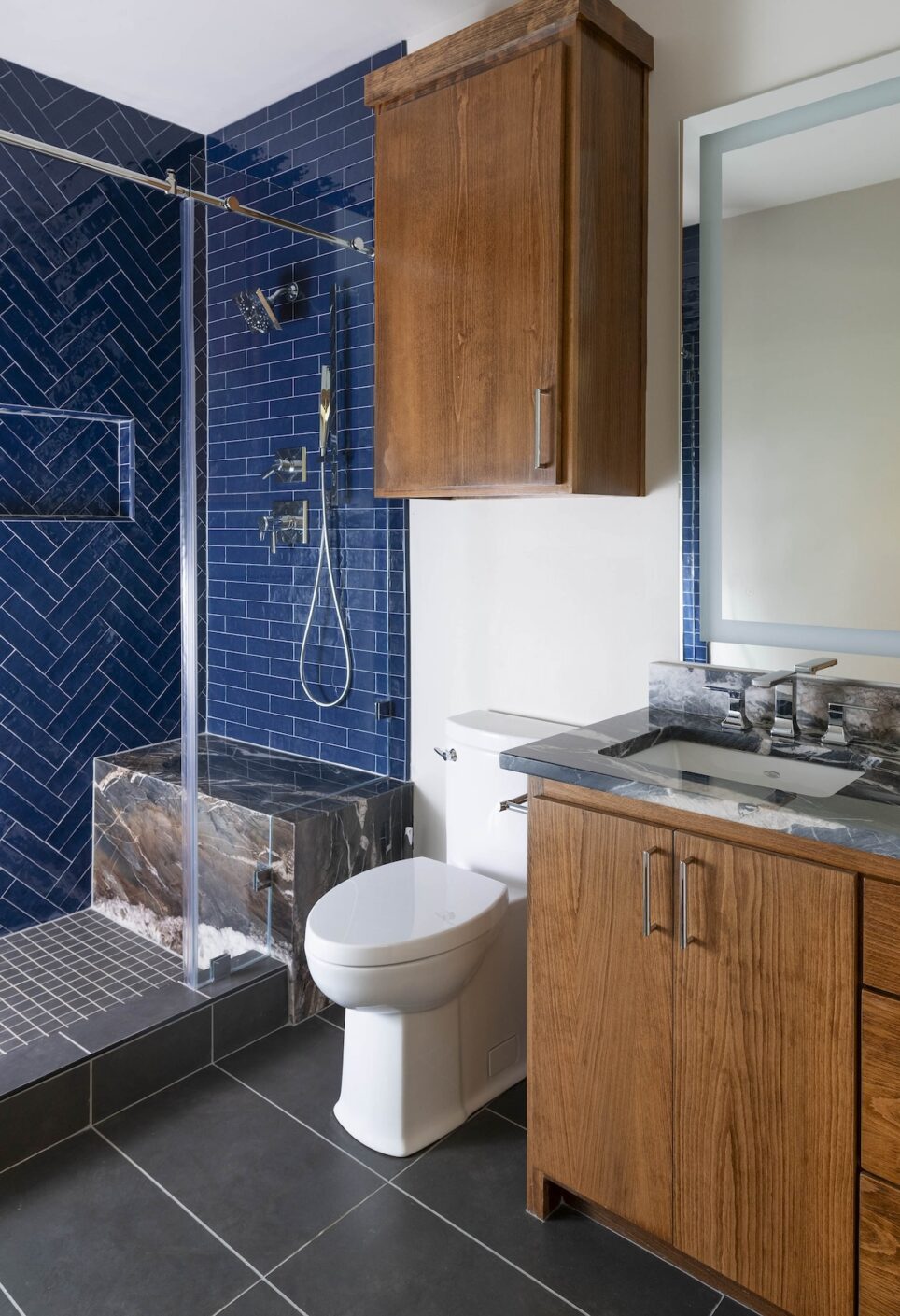 Blue Shower Tile Wood Cabinetry Bathroom Design